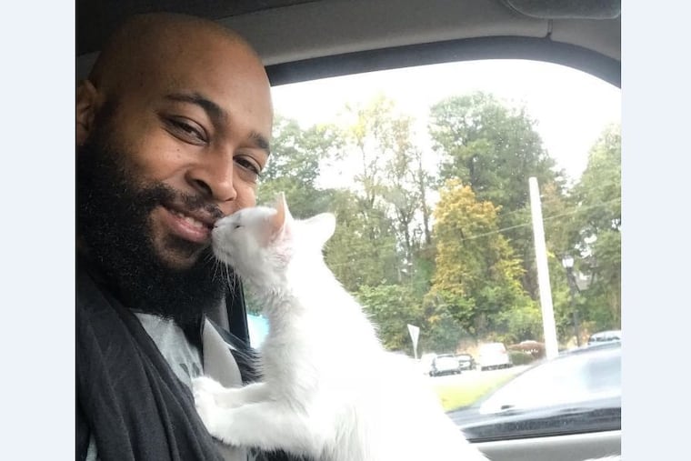Sterling Davis with his cat, Damita Jo, in 2018.