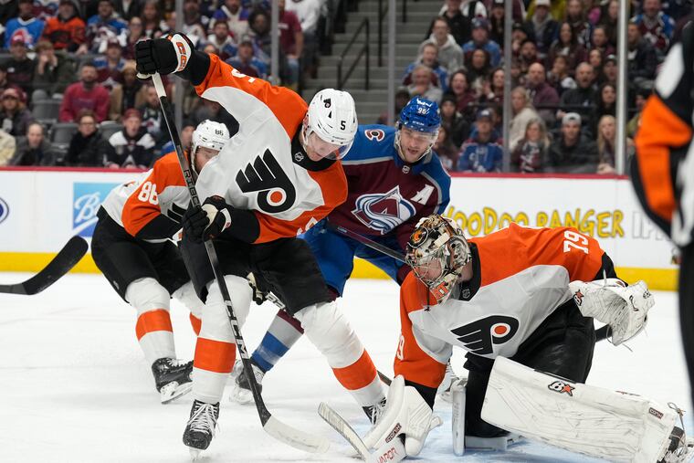 Flyers defenseman Egor Zamula clears the puck after a save by Flyers goaltender Carter Hart on a shot by Colorado Avalanche right wing Mikko Rantanen on Dec. 9.
