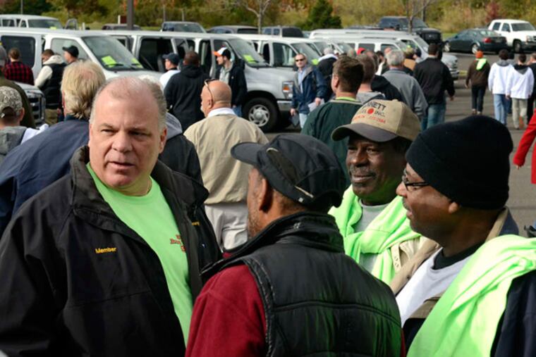 Senate President Stephen Sweeney (left) helps send off volunteers leaving a get-out- the-vote rally at Camden County Democratic headquarters in Cherry Hill. (Tom Gralish / Staff)