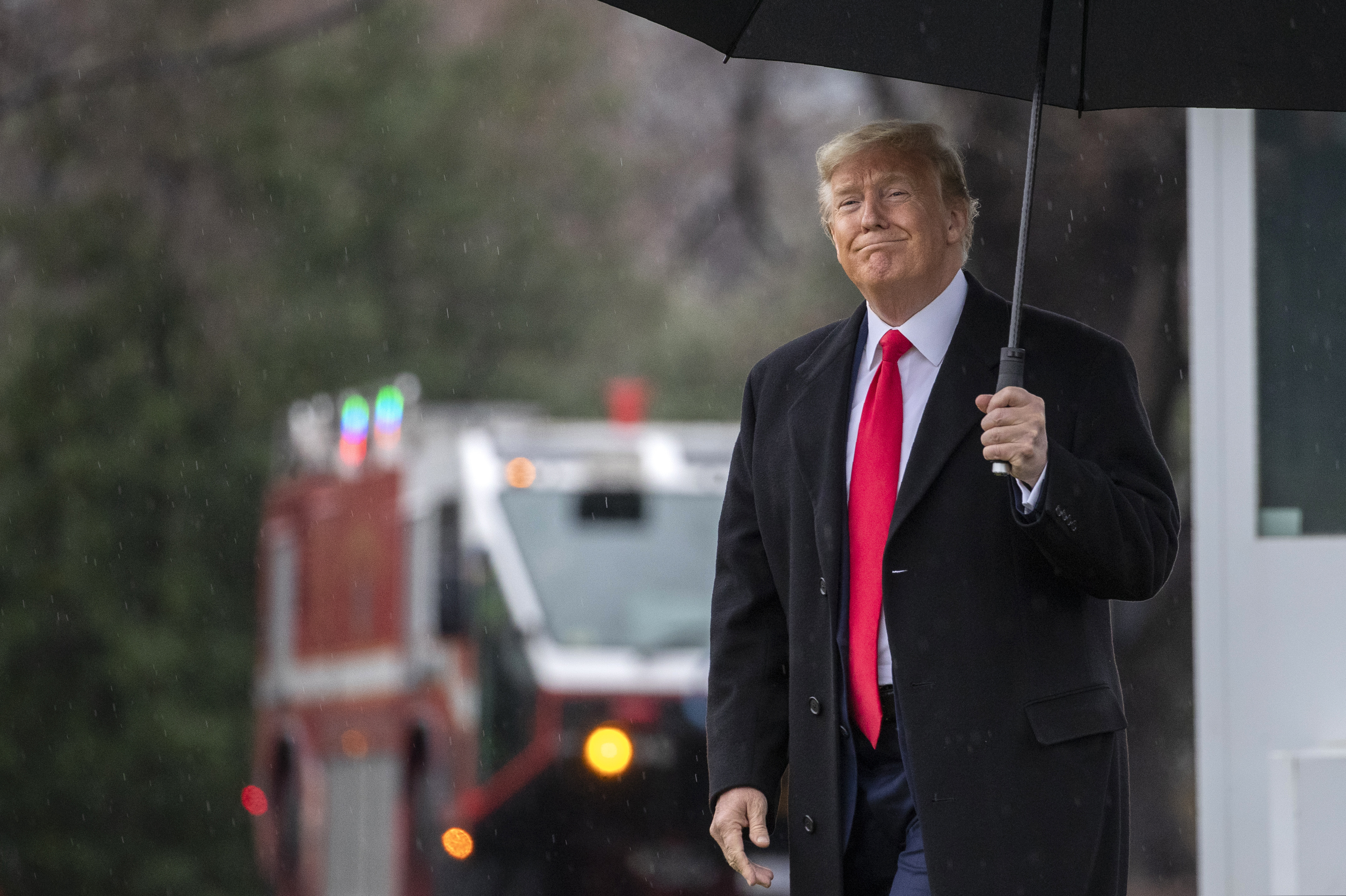 President Donald Trump walks on the South Lawn as he leaves the White House.