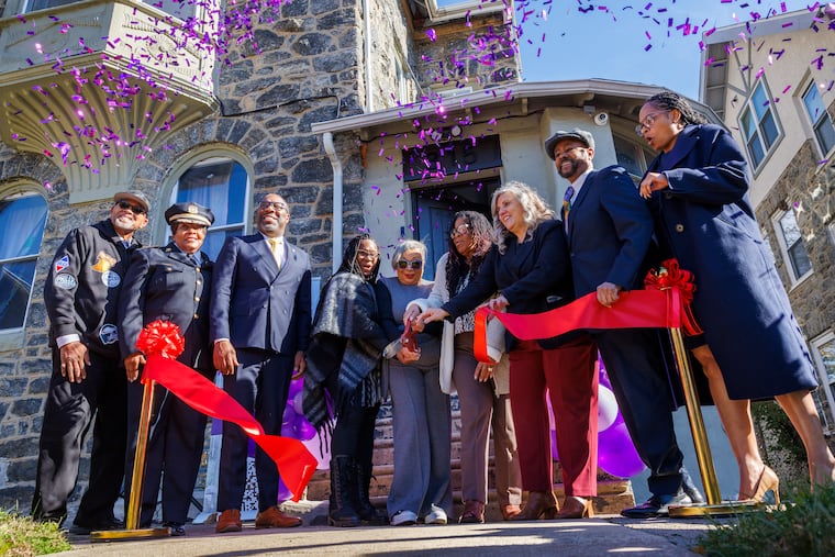 Toni Willis (center with scissors) founder of Ardella’s House cuts the ribbon surrounded by other dignitaries outside Ardella’s House's second location on North 63rd Street,