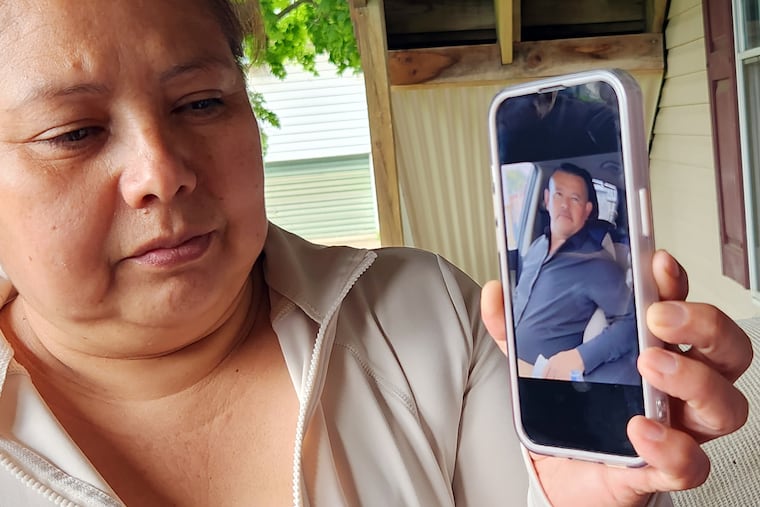 Maria Hernandez looks at a photo of her husband, Erasmo, at their home in Temple, Berks County.
