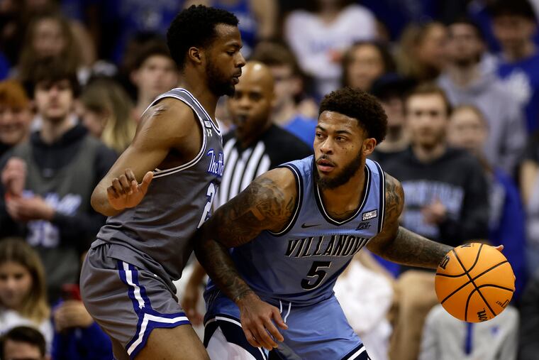 Villanova guard Justin Moore (5) looks to pass around Seton Hall guard Femi Odukale during the second half of an NCAA college basketball game on Tuesday in Newark, N.J. Villanova won 76-72.