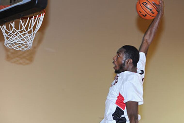 Imhotep's Khyree Wooten goes for the dunk off a breakaway in in a 65-46 win over Del-Val. (Sarah J. Glover/Staff Photographer)