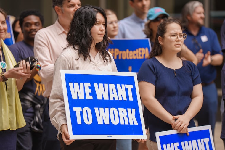 Federal employees and supporters held signs reading "We want to work" at a rally for EPA workers who were put on leave after signing a letter critical of the Trump administration, in Philadelphia on July 9.