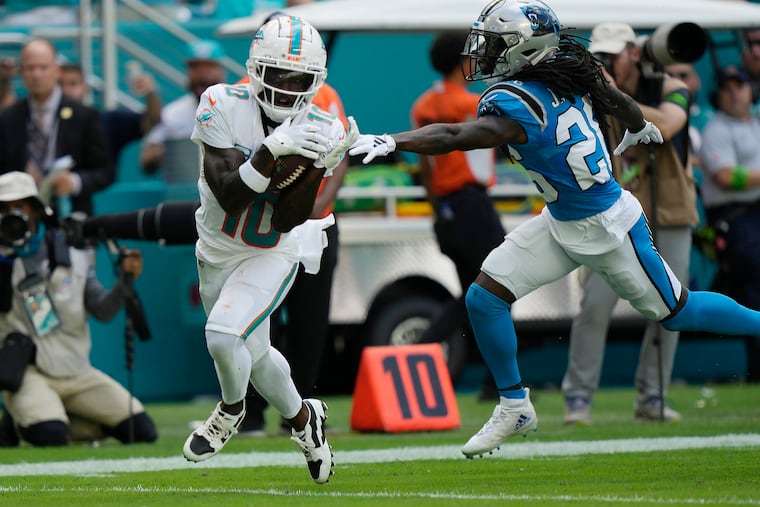 Miami Dolphins wide receiver Tyreek Hill catches a touchdown pass as Panthers cornerback Donte Jackson is late with the tackle last Sunday.