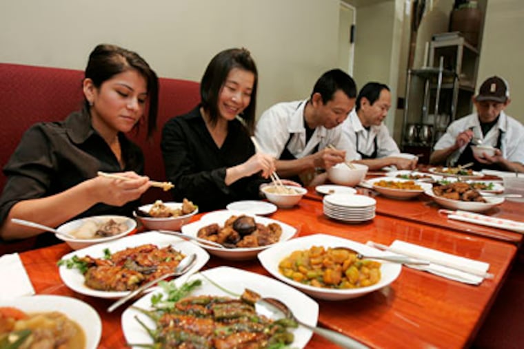 At Hunan in Ardmore, members of the staff - Zulmary Torres, Min Wu, Jiu Lou, Lak Ley, and Savy Kohna - eat together three times a day. Staff meals at other local eateries vary: New menu items may be tested, young chefs may show off their skills, dining-room leftovers may be dressed up and served anew. (DAVID SWANSON / Staff Photographer)