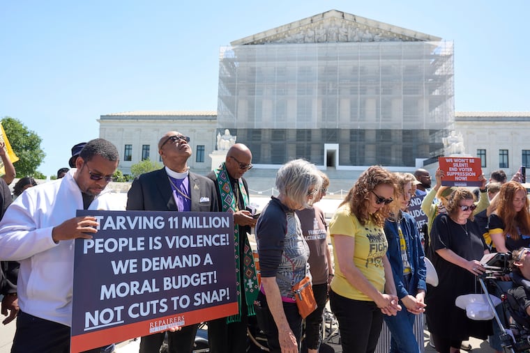 Activists with the Poor People's Campaign protest against spending reductions across Medicaid, food stamps, and federal aid outside the Supreme Court Building in June 2025.