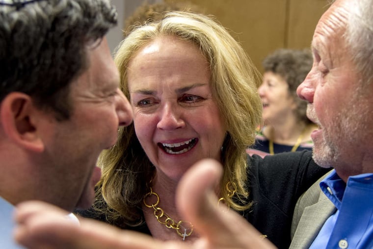 Fourth Congressional District candidate Madeleine Dean is greeted by her older brother Bob Dean (right) and longtime friend Rabbi Larry Sernovitz at her primary watch party on Tuesday.