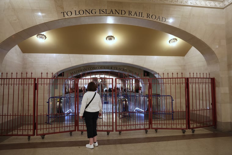 A passenger looks at a closed off entrance to the Long Island Rail Road at Grand Central station, Saturday, May 16, 2026, in New York, on the first day of a strike after five unions representing about half the LIRR's workforce walked off the job.