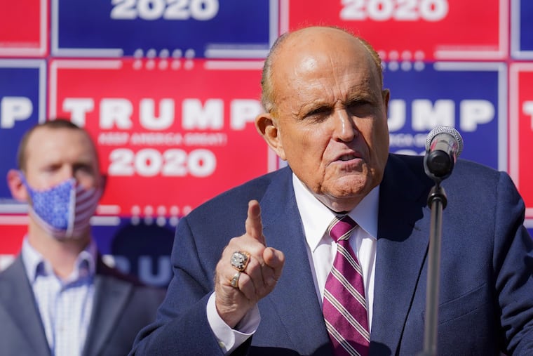 Former New York mayor Rudy Giuliani, a lawyer for President Donald Trump, addresses reporters during a news conference at Four Seasons Total Landscaping in the Northeast on Nov. 7, 2020.