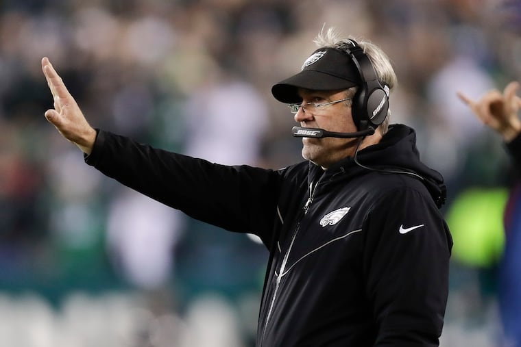 Eagles Head Coach Doug Pederson raises his arm against the Dallas Cowboys on Sunday, December 22, 2019 in Philadelphia.