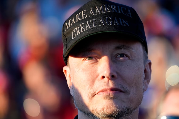 FILE - Tesla and SpaceX CEO Elon Musk listens as Republican presidential nominee former President Donald Trump speaks at a campaign event at the Butler Farm Show, Oct. 5, 2024, in Butler, Pa.