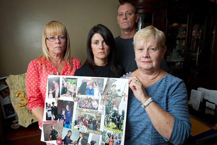 The family of Timothy Gill, a Philly firefighter and Iraq war veteran who committed suicide. From the foreground: his mother Marie Gill; wife Maria Gill; sister Cheryl Philyaw; and older brother William Gill. The family says he suffered from post traumatic stress disorder. (ALEJANDRO A. ALVAREZ / STAFF PHOTOGRAPHER )
