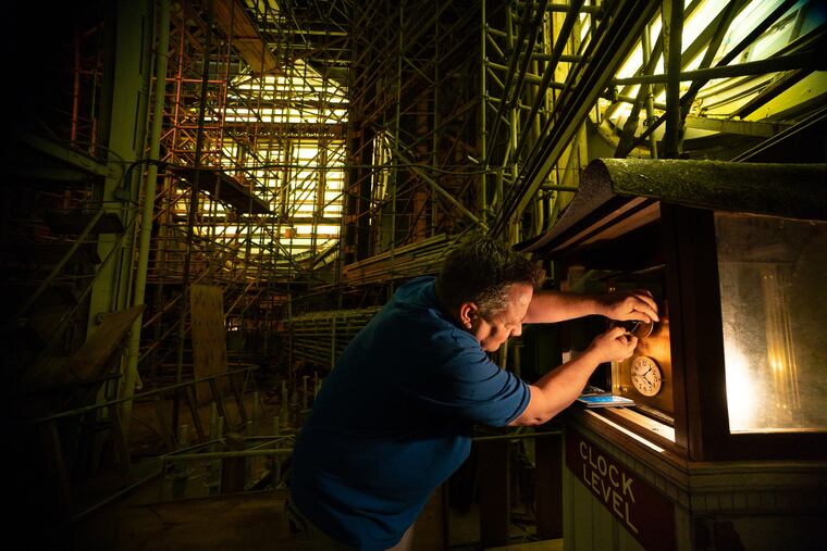Around 4 a.m. on Sunday morning, March 10, 2019. building service manager Joe Brasky adjusts one of the City Hall Tower clocks to daylight savings time. Each of the four massive clocks is controls by a small timepiece.