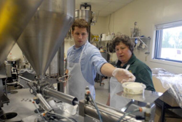John Fissinger 3d, eldest son in the third generation, and his mother, Sue, weigh the cheese spread before shipping. She took over her mother’s business, founded in the 1970s, in 1980.