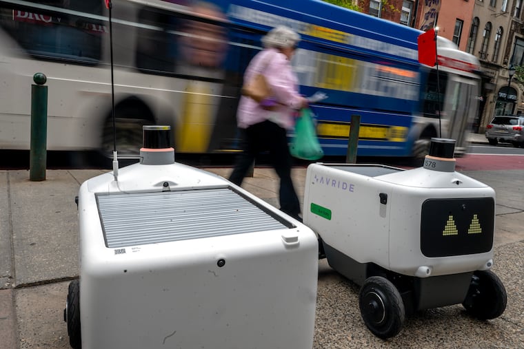 Two Uber delivery robots are parked and apparently waiting for orders in the 1900 block of Chestnut Street on May 13.