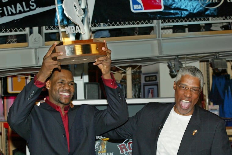 NBA legend Julius 'Dr. J' Erving, right, pats LeBron James on the back after James was officially presented the NBA Rookie of the Year award at the NBA Store on New York's 5th Avenue, April 20, 2004.