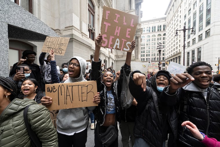 Philadelphia students protest on Tuesday outside Philadelphia City Hall. The young people - about 100 students from Science Leadership Academy at Beeber, were protesting the Philadelphia School District's special-admissions changes, which have had the ripple effect of under-enrollment at a number of city magnets, and subsequent school-based budget cuts planned for next year.
