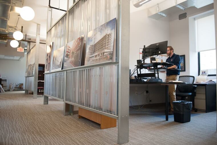 Estimator David Gyurina works at a standing desk in one of the newly renovated open offices at The Drexel Building in Philadelphia, PA. on Friday, Feb. 9, 2018. Clemens moved into the Drexel Building in 1995 but expanded to a new floor last year as the company’s volume of work increased. The floor’s open design is meant to encourage interaction between employees.
