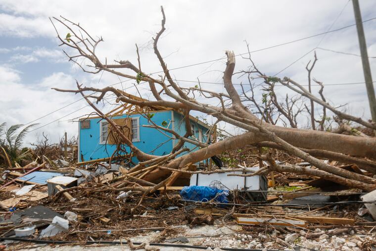 In this Sept. 19, 2019 photo, buildings in Marsh Harbor on the island of Abaco in the Bahamas, are devastated by the effects of Hurricane Dorian. Many Bahamian schools remain closed weeks after the storm due to a lack of clean water.