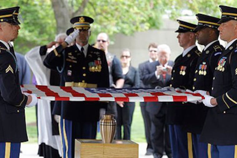 An American flag is folded by the Casket Team at Arlington National Cemetery during the inurnment service Friday morning for John P. Wheeler, III, who served in the Army from 1966 to 1971. (AP Photo / Alex Brandon)