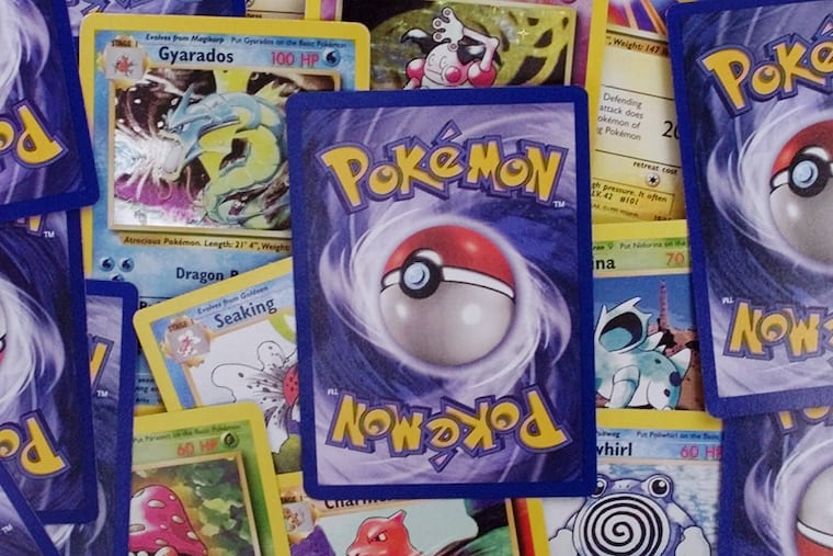 In this file photo, a selection of Pokemon trading cards are displayed in Scituate, Massachusetts. Officials say a Pokémon card worth $24,000 was stolen using fake cryptocurrency in Marlton.