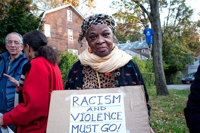 George Vucelich has a skeleton hanging from a tree in his Swarthmore yard with a rope around its neck and wearing an Obama Biden T shirt. The display has angered and upset neighbors who asked him to take it down, he has refused and they have in response demonstrated daily. Here, Betty Ann Wilson, 72, of Swarthmore was one of about a dozen protesters outside of Vucelich's house on Monday, Oct. 28, 2013. ( ED HILLE / Staff Photographer )