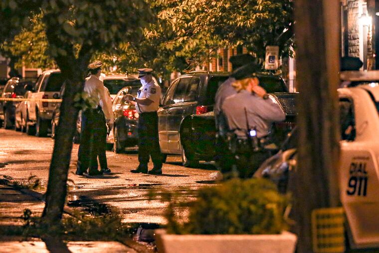 Philadelphia Police congregate in the 1600 block of Annin Street in Point Breeze after a man was fatally shot there Thursday, April 30, 2020.