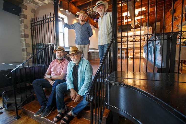 The people from the Tin Angel, seated left to right, Donal McCoy, and Richard Kardon and standing left to right, Jessie Lundy and Lawrence Goldfarb, are opening a new music club in Manayunk called the Locks at Sona , on the second floor of the Irish bar Sona on Main Street. MICHAEL BRYANT / Staff Photographer
