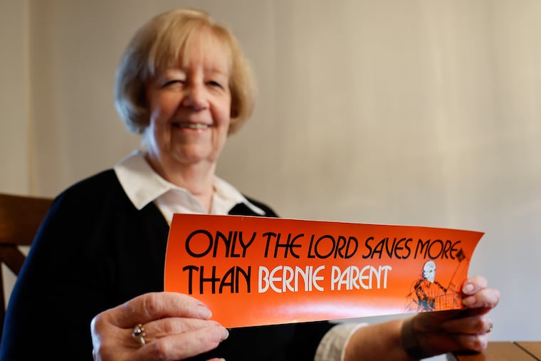 Linda Mitchell holds a “Only the Lord saves more than Bernie Parent” bumper sticker made by her late husband, Bob Mitchell, in 1974 that still resonates today.