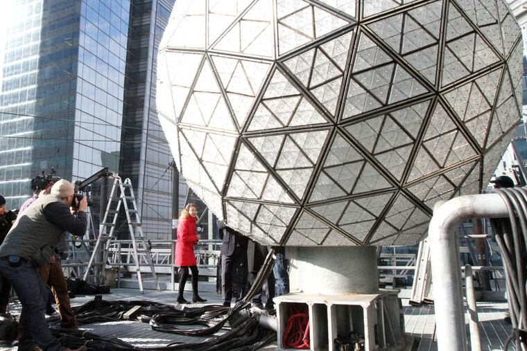 ASSOCIATED PRESS The New Year's Eve Ball (above) is assembled on the roof of One Times Square in New York. It features a crystal with a rose design (bottom right) based on a drawing (bottom left) by a 12-year-old.