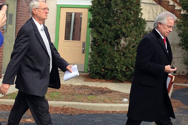 Richard Como, left, walks out of district court Monday afternoon with his lawyer after his arraignment on theft charges.