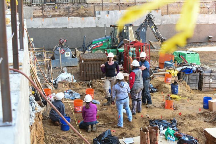 Volunteer archeologists work to exhume bodies buried at the Former First Baptist burial ground as a construction company prepares to erect an an apartment building. BRIANNA SPAUSE / Staff Photographer
