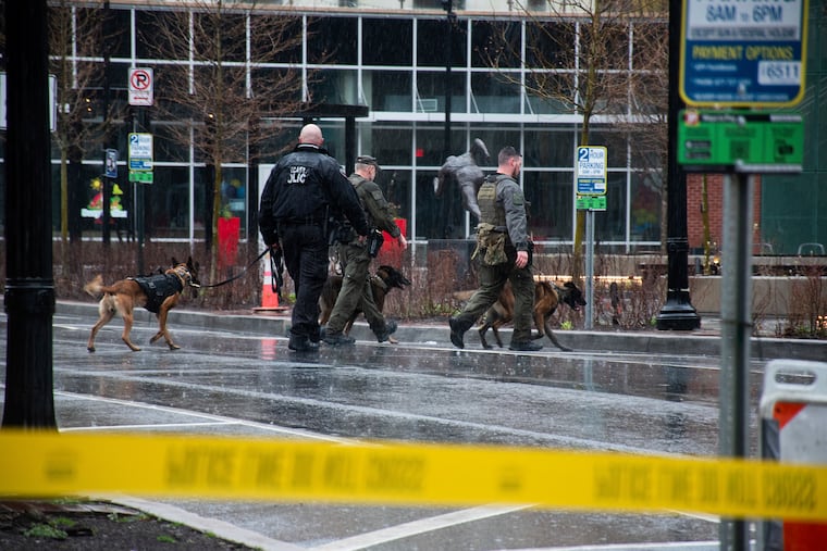 Police K9s patrol around the blocked off 100 block of Queen Street in Lancaster on Saturday. The drag queen story hour at the Lancaster Public Library was canceled after police responded to a suspicious package discovered inside the building.