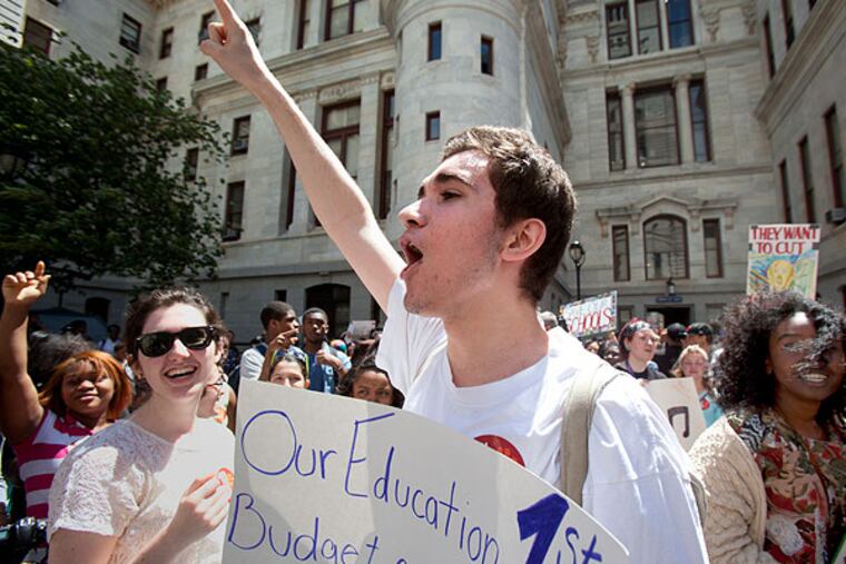 Ensar Tota, a sophomore as Masterman leads a chant with frllow student protesters in the courtyard of city hall.An estimated 1500 students rallied outside the School District of Philadelphia headquarters on Broad St. Friday afternoon protesting against cuts in school funding. The group then marched to City Hall and continued their protest there. ( ED HILLE / Staff Photographer )
