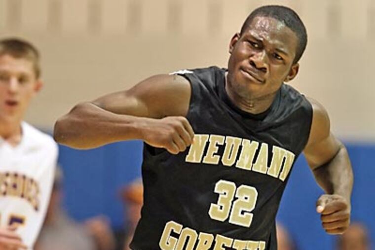 Neumann-Goretti's Lamin Fulton pumps his fists after Billy Shank nailed one of his six three-pointers against Lancaster Catholic. (Steven M. Falk/Staff Photographer)