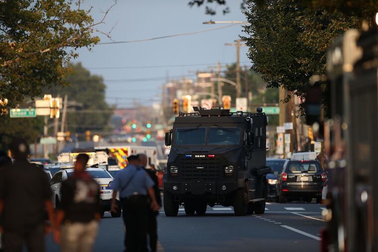 Law enforcement officers respond to a shooting on Wednesday, Aug. 14, 2019, in Philadelphia. At least six police officers were wounded in an hours-long standoff with a gunman that prompted a massive law enforcement response in the city's Nicetown-Tioga neighborhood.