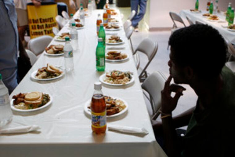 At the Chosen 300, a ministry that feeds the homeless, a man waits in the 11th and Spring Garden Street building for others. But Alan Bruckner of Philly Restart, which runs feedings on the Parkway, said: "I get the feeling it's, 'Let's get this out of the way, let's get this out of the public's eye.' "