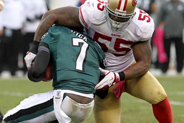 Michael Vick gets sacked by the 49ers' Ahmad Brooks in the third quarter on Sunday. (Charles Fox/Staff Photographer)