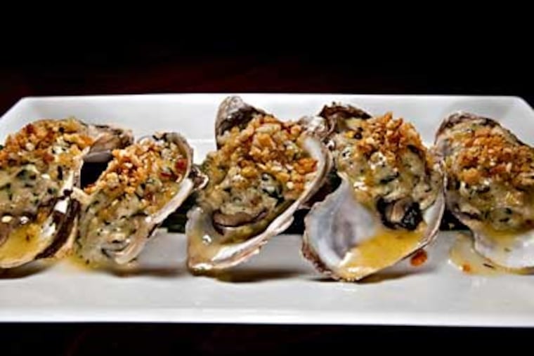 Roast oysters with crabmeat stuffing, saffron and thyme. (DAVID M WARREN / Staff Photographer)