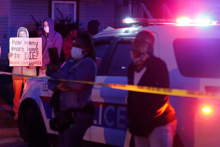 A crowd gathers to protest in the neighborhood where a Columbus, Ohio, police officer fatally shot a teenage girl on Tuesday.