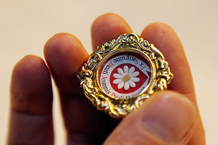 The Rev. Pawel Kryszkiewicz, pastor of St. Joseph's parish in Camden, holds a relic of Pope John Paul II. (AKIRA SUWA / Staff Photographer)
