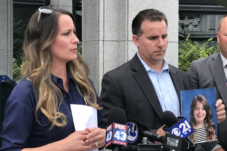 Kathryn Sherlock, left, speaks outside the state Capitol after meeting with Gov. Tom Wolf on Friday, Sept. 7, 2018. Her husband, Brian Sherlock, right, holds a photo of Kathryn's daughter and his stepdaughter, Kayden Mancuso.