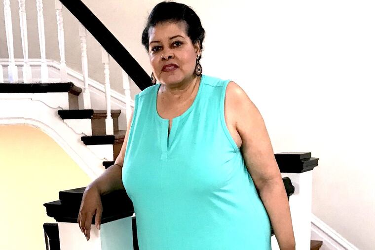 Brenda Harrison outside her fourth-floor apartment.