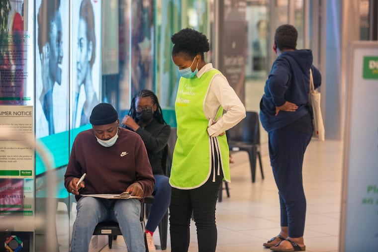 People wait to get vaccinated at a shopping mall, in Johannesburg, South Africa, on Friday.