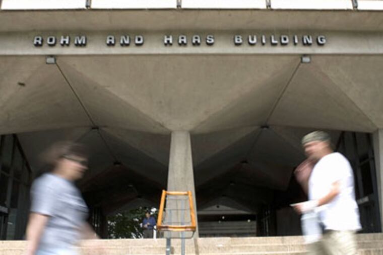 In this July 10, 2008 file photo, pedestrians walk near the Rohm and Haas Co. headquarters in Philadelphia. The specialty chemicals maker said Tuesday, Jan. 20, 2009, it's cutting about 900 jobs, idling or closing plants and will record $90 million in pretax charges for the fourth quarter. (AP Photo / Justin Maxon, file)