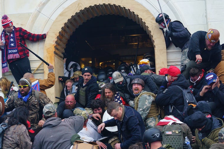 Insurrectionists clash with police at a door to the U.S. Capitol on Jan. 6.