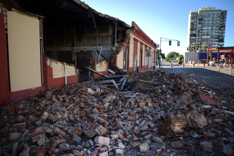 Debris from a collapsed wall of a building litters the ground after an earthquake struck Puerto Rico before dawn, in Ponce, Puerto Rico, Tuesday, Jan. 7, 2020. (AP Photo/Carlos Giusti)
