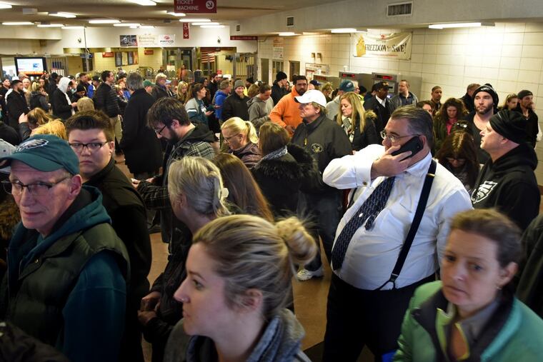 PATCO ticket buyers wait in a long circular line at the Woodcrest station.